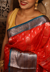 Orangish Red Satin Pattu Kanjivaram Saree with Teal Blue Border