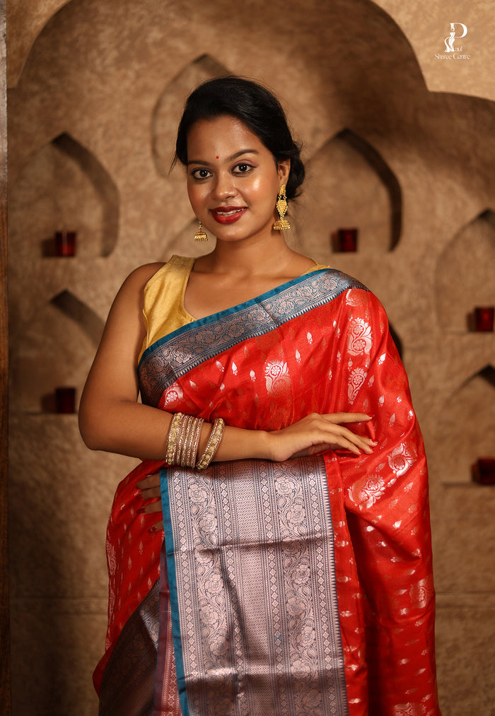 Orangish Red Satin Pattu Kanjivaram Saree with Teal Blue Border